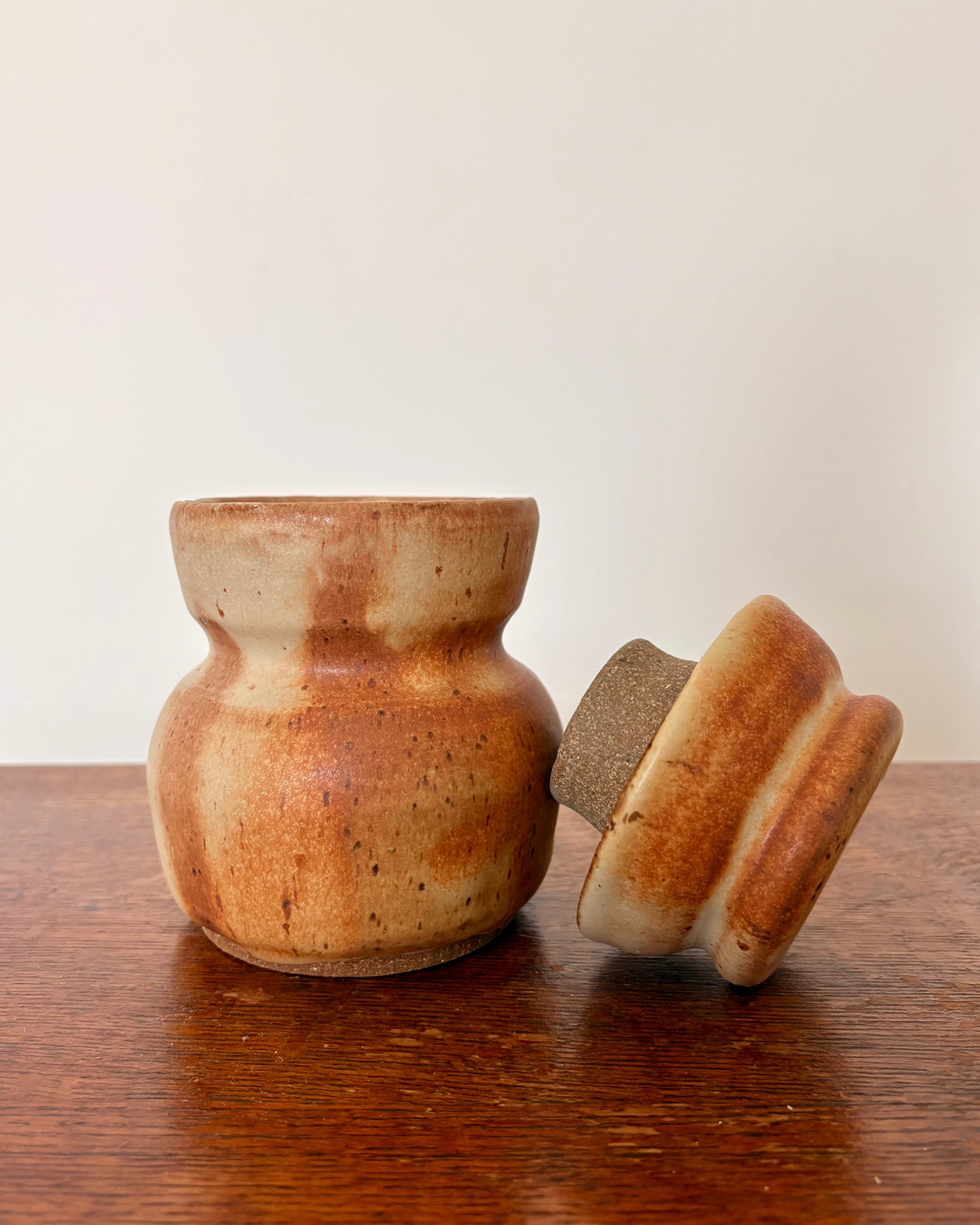 Ceramic jar with a lid on a wooden surface